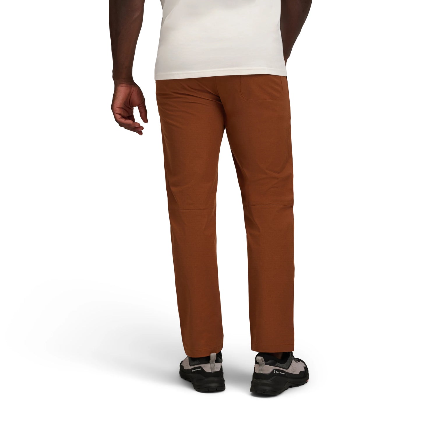 Brown pants worn by a person on a white background