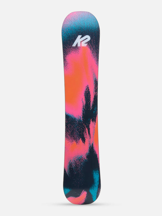 A K2 snowboard shown vertically against a light gray background, featuring a vibrant abstract design with pink, orange, teal, and black splatters, and the white K2 logo near the top.
