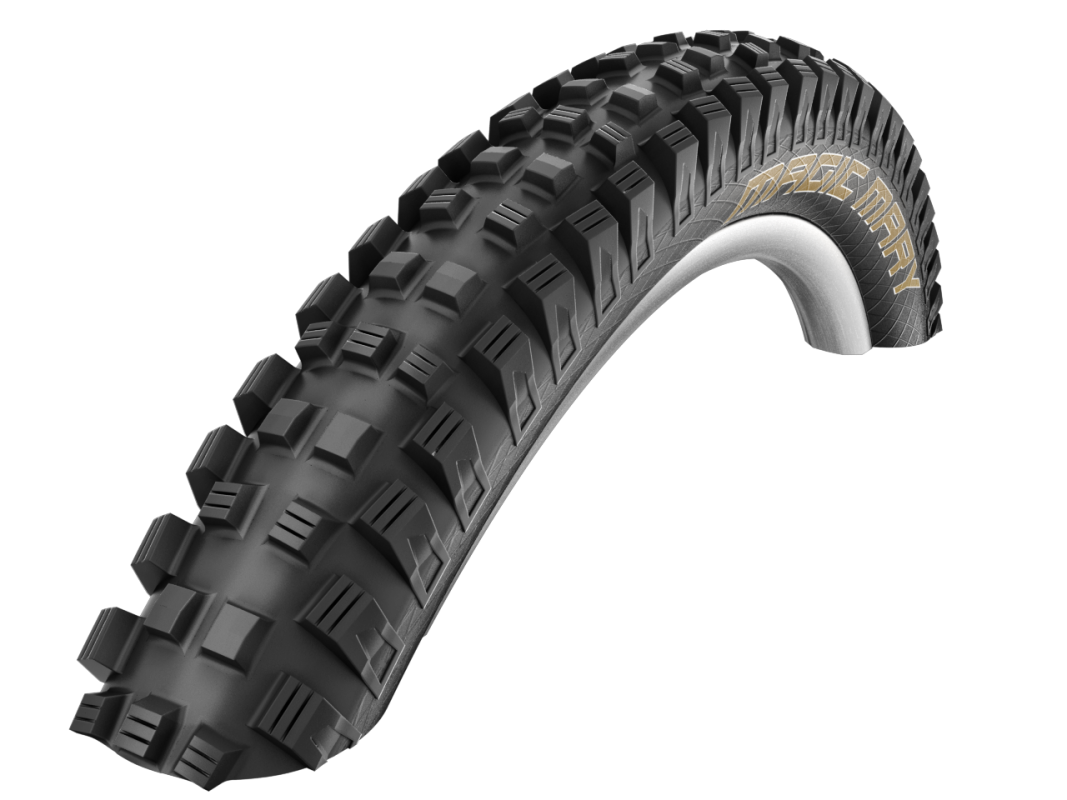 Black off-road tire with tread pattern on a white background