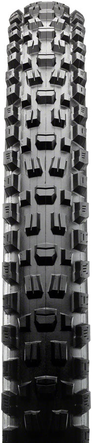 Close-up of a tire tread pattern with prominent knobs on a black background