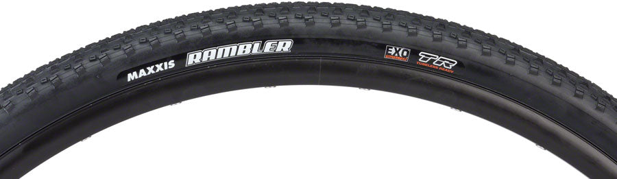 Close-up of a Maxxis bicycle tire with tread pattern and branding on a white background