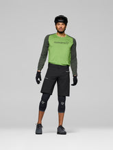 Load image into Gallery viewer, Person wearing a green and gray long-sleeve shirt with black shorts on a gray background