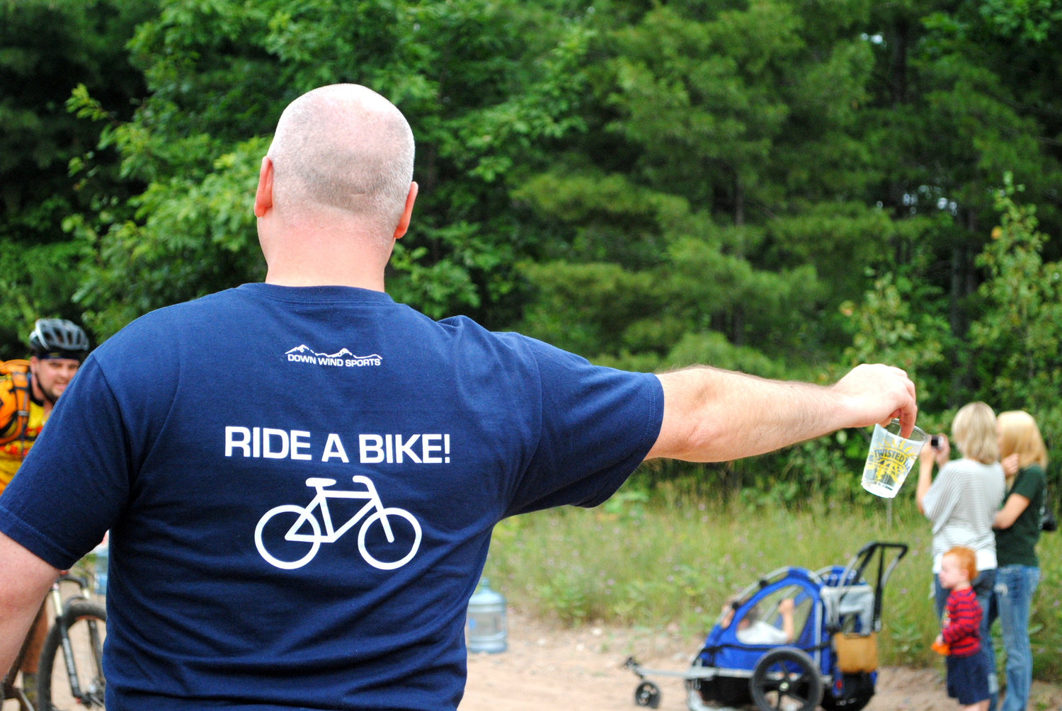 Ride A Bike! Man hands out water during a bicycle race in the Upper Peninsula.