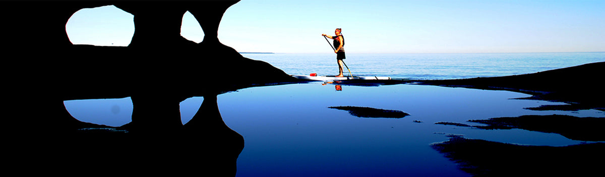 Woman Stand Up Paddle boarding on Lake Superior near Marquette in Michigan's Upper Peninsula