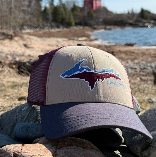  cap with a logo on a rocky cliff background