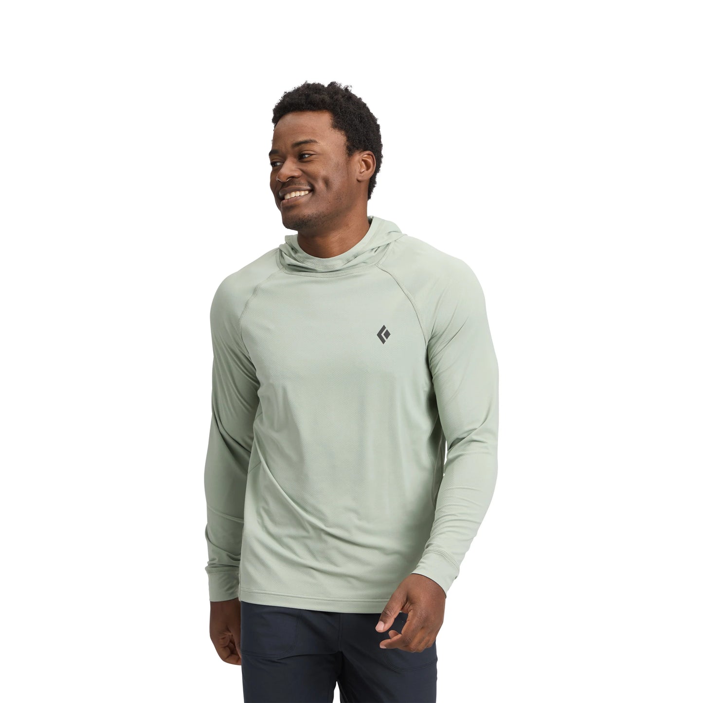 Man wearing a light green hoodie with a brand logo on a white background