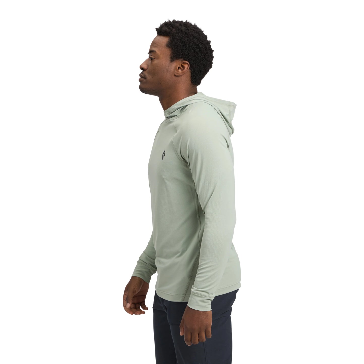 Man wearing a light green hoodie on a white background
