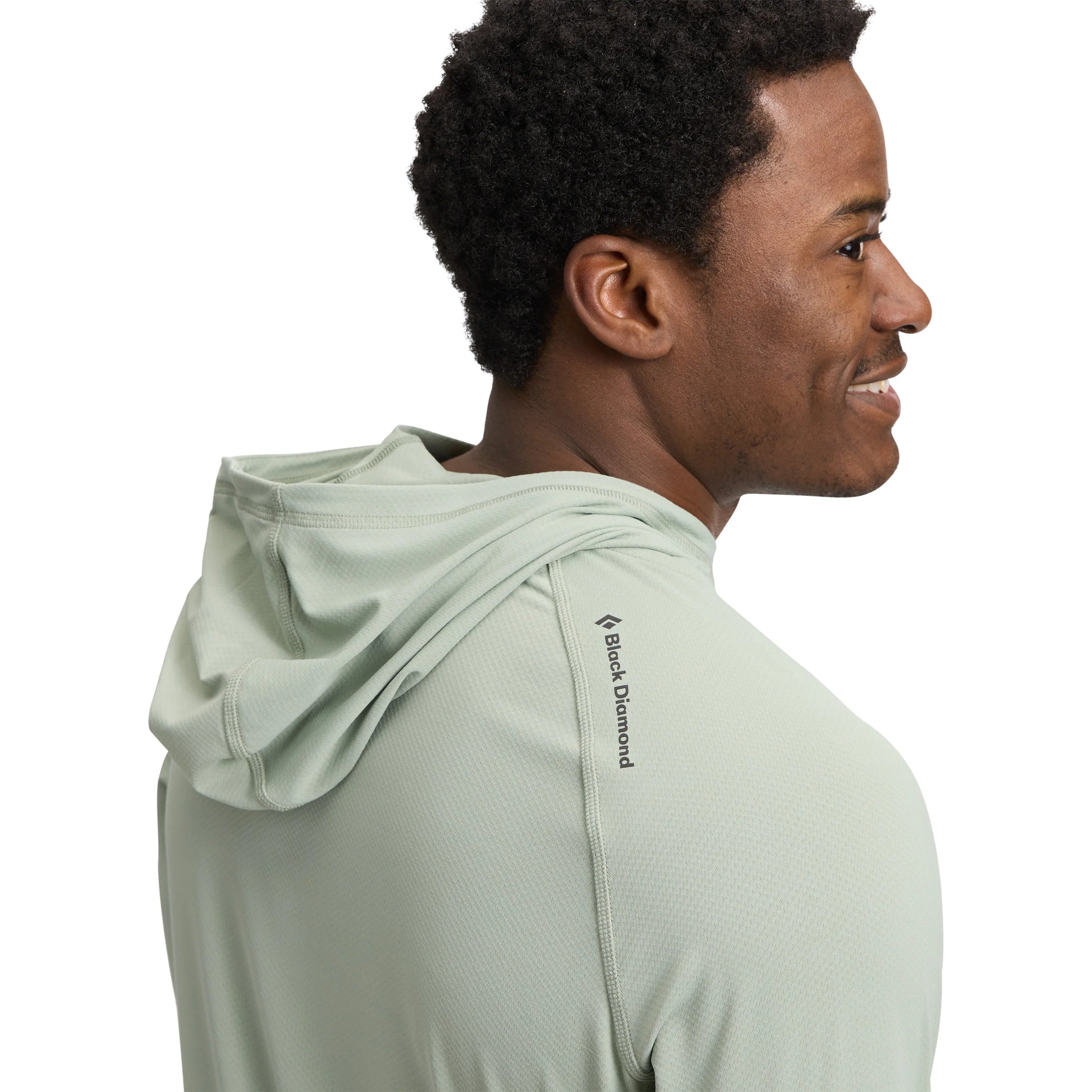 Man wearing a light green hoodie with Black Diamond logo on a white background