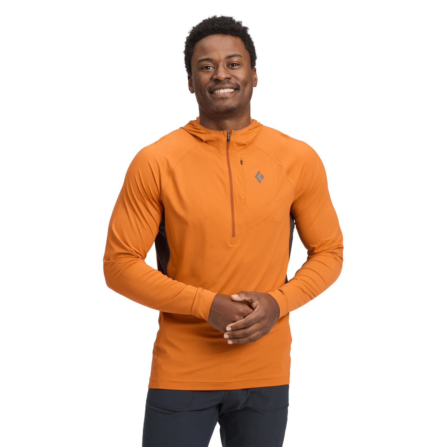 Man wearing an orange pullover with a brand logo on a white background