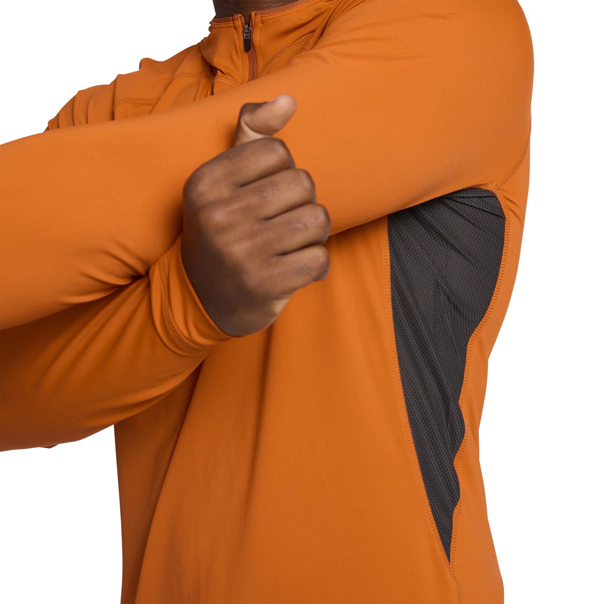 Person wearing an orange jacket with a black sleeve patch, showing a thumbs-up gesture.
