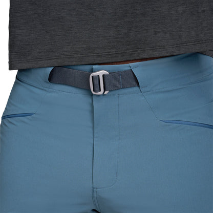 Blue pants with a black belt and buckle, worn by a person.