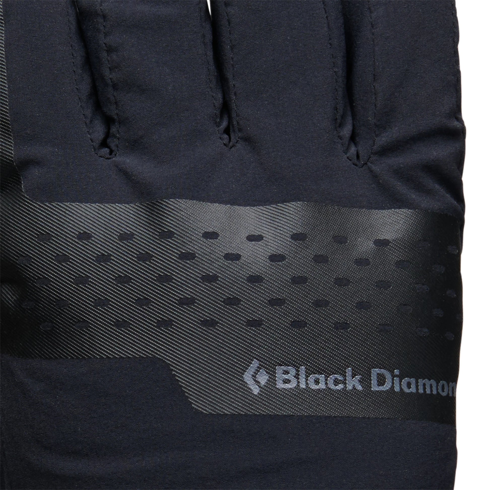 Close-up of a black jacket with Black Diamond logo on a white background