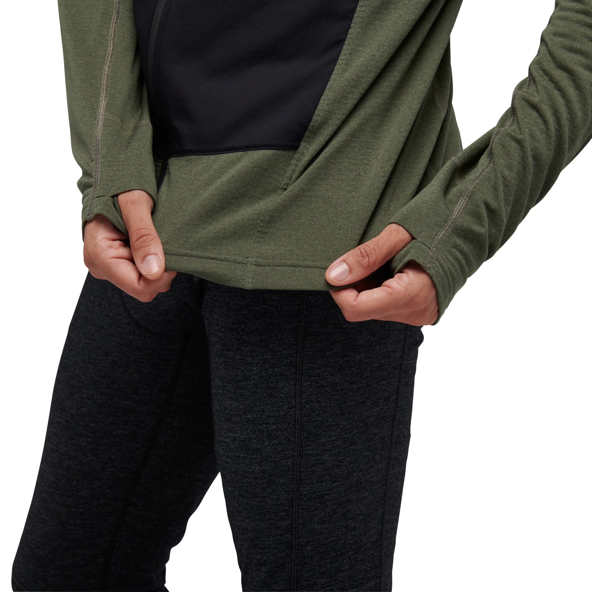 Person wearing a green long-sleeve shirt and black pants on a white background