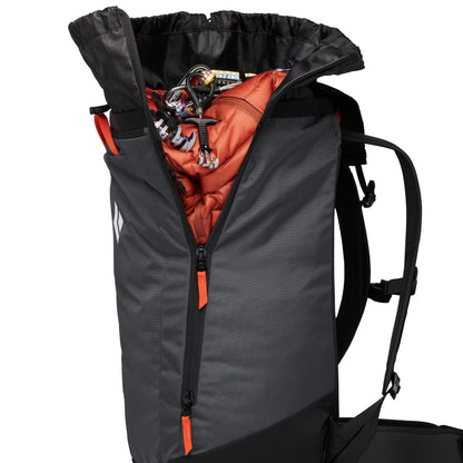 Gray backpack with orange interior showing a jacket inside on a white background