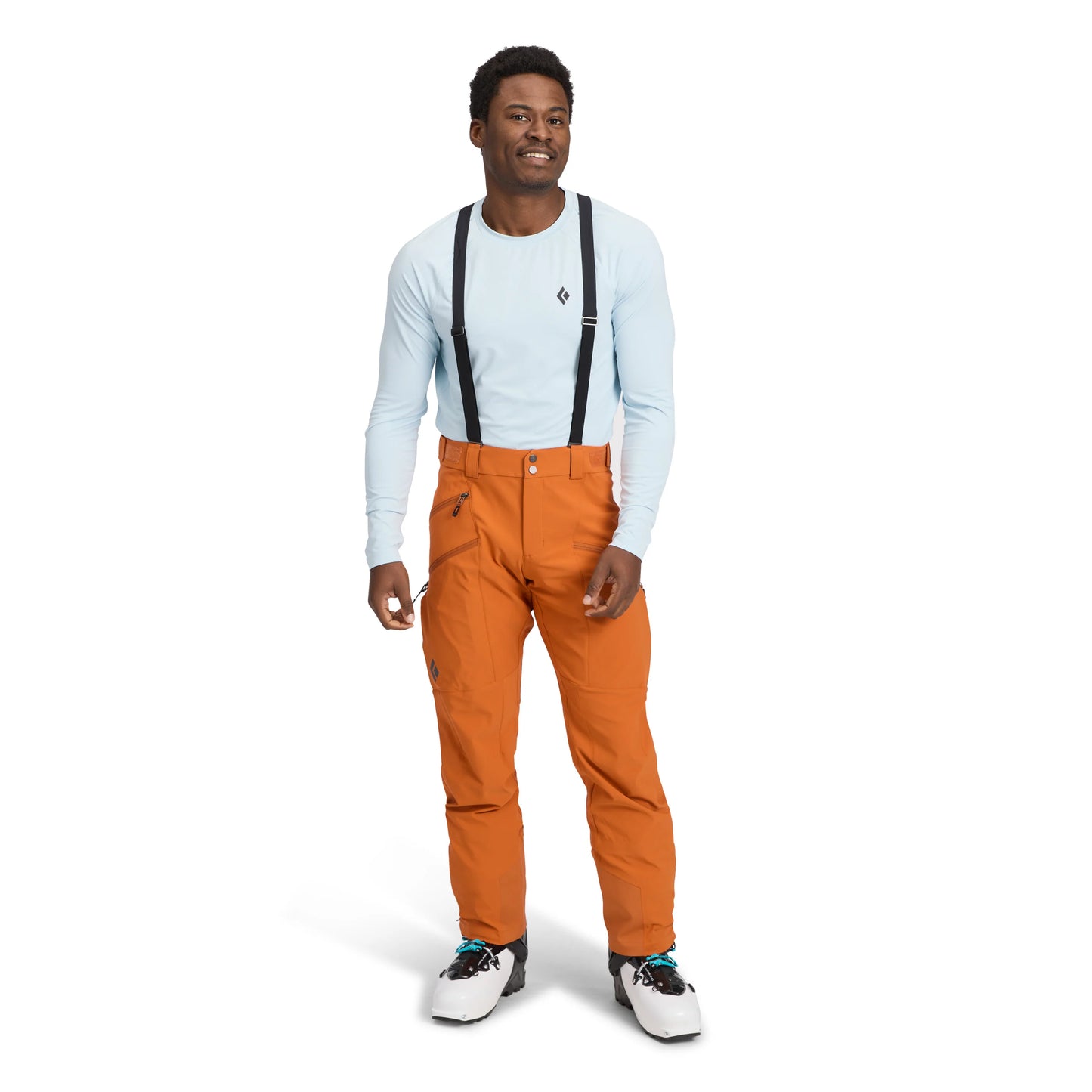 Man wearing orange pants with suspenders on a white background