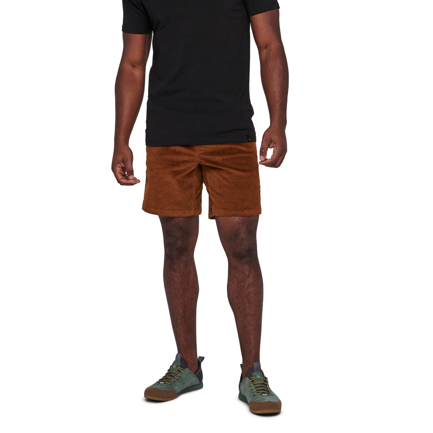 Person wearing brown shorts and a black shirt on a white background