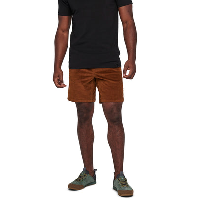 Person wearing brown shorts and a black shirt on a white background