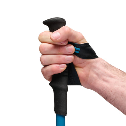 Hand gripping a blue and black golf club with a close-up view on a white background