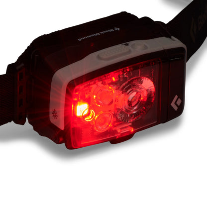 red LED of Black diamond headlamp on white background