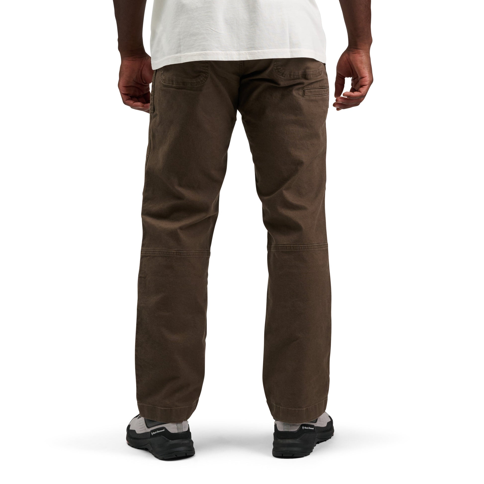 Brown pants worn by a person on a white background