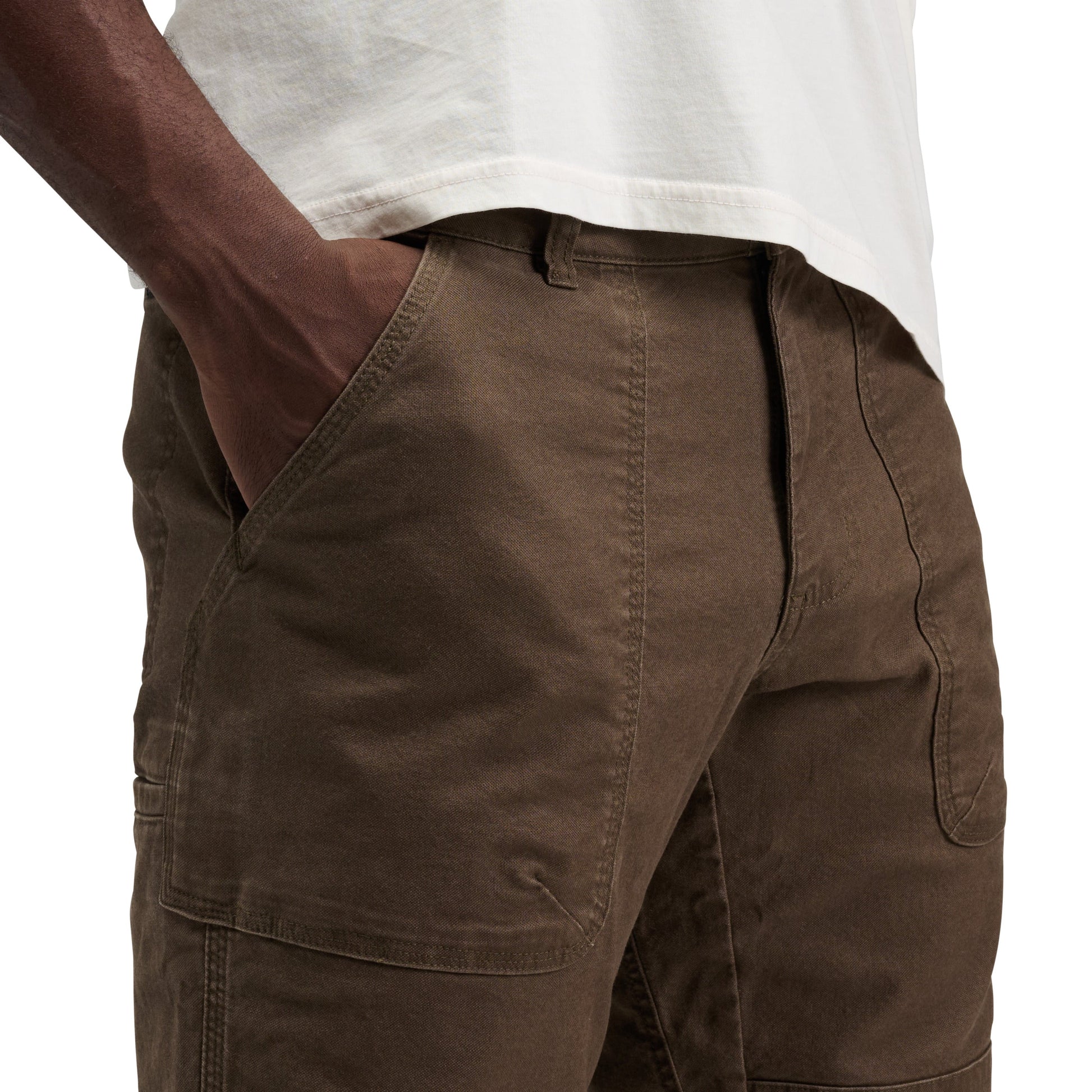 Brown pants worn by a person on a white background