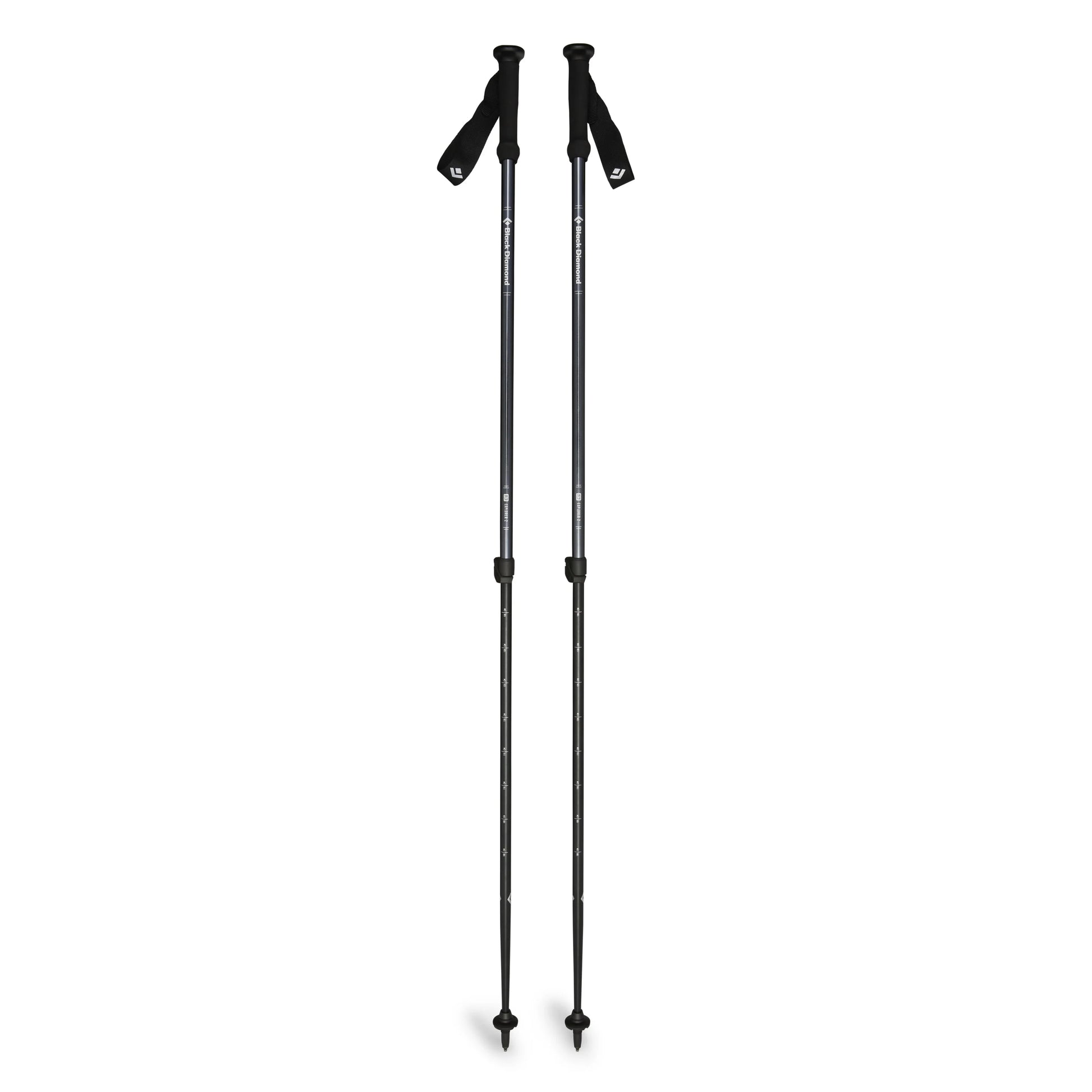 Two black hiking poles on a white background