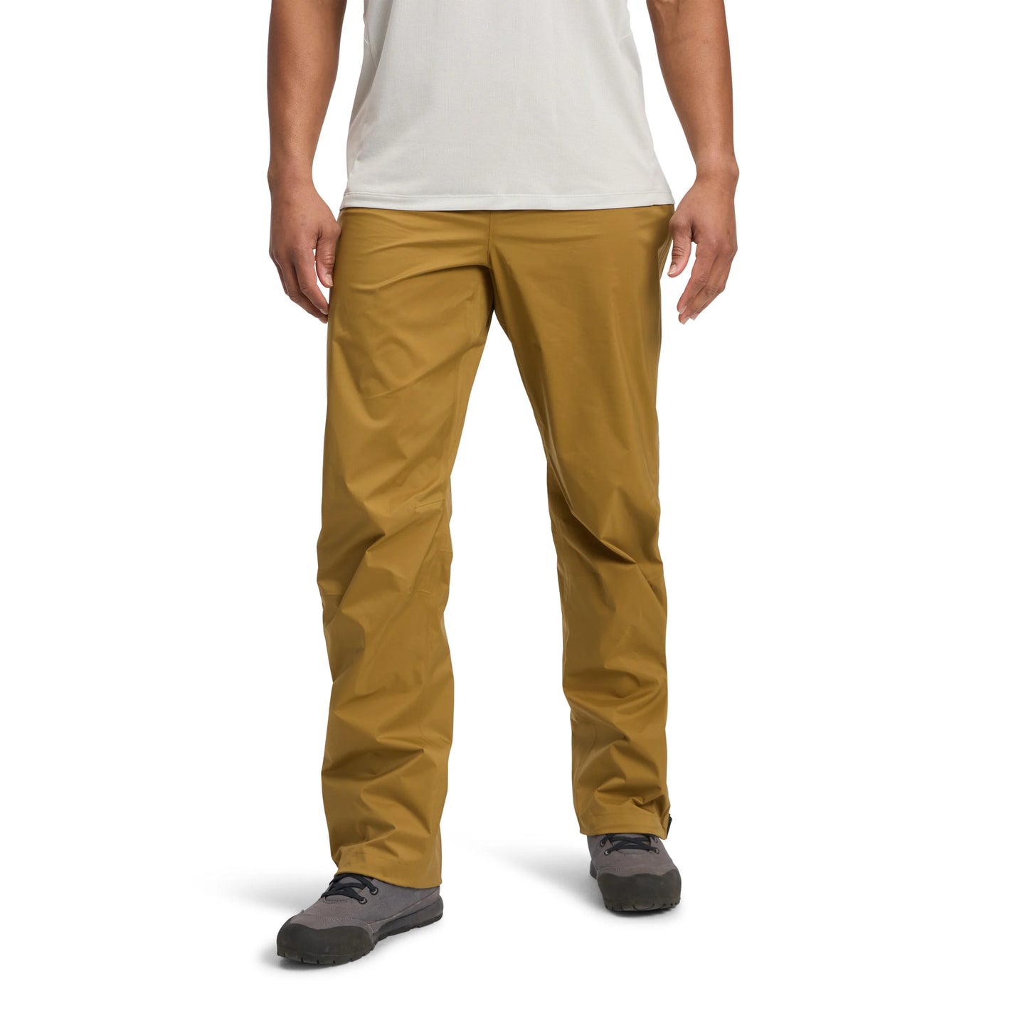 Person wearing mustard yellow pants on a white background
