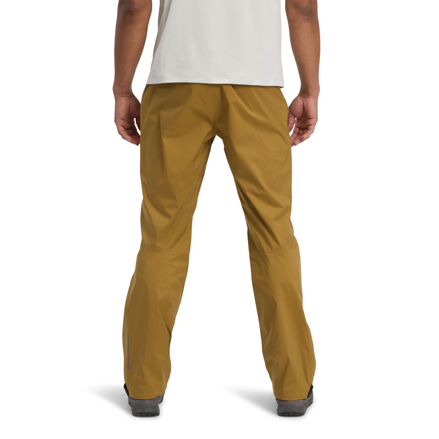 Mustard yellow pants worn by a person on a white background