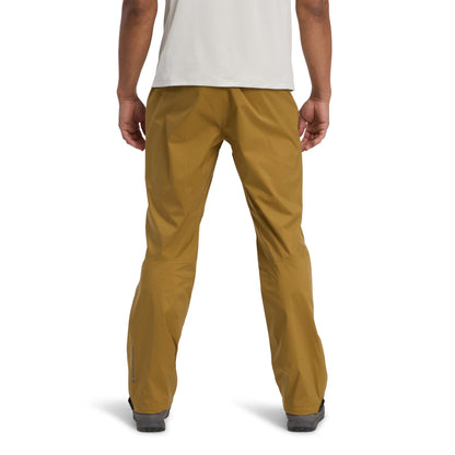 Mustard yellow pants worn by a person on a white background