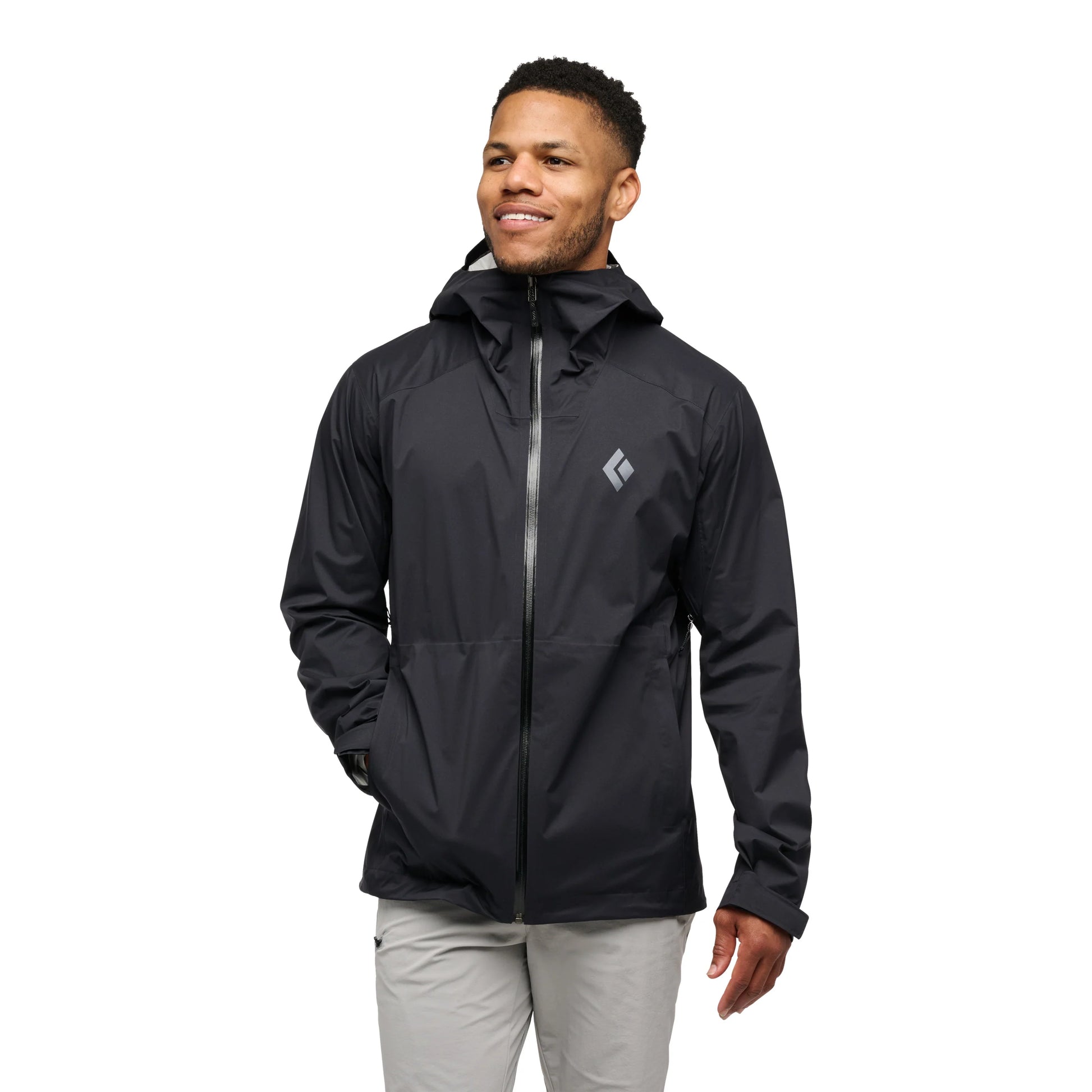 Man wearing a black jacket with a brand logo on a white background