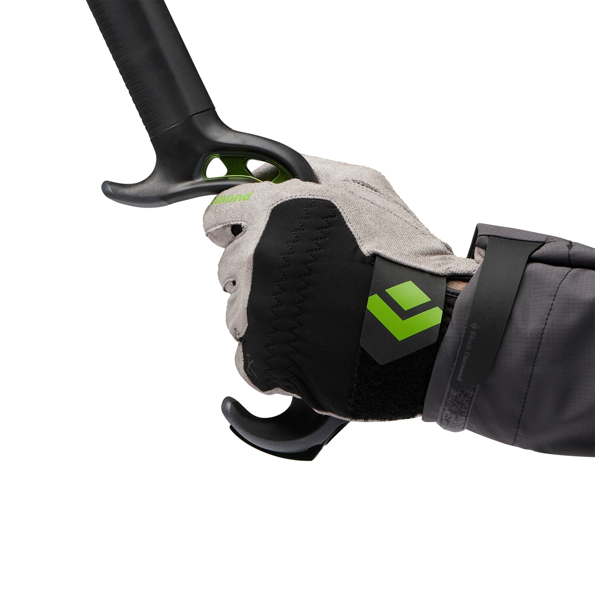 Hand wearing a black glove with a green logo holding onto a black pole against a white background