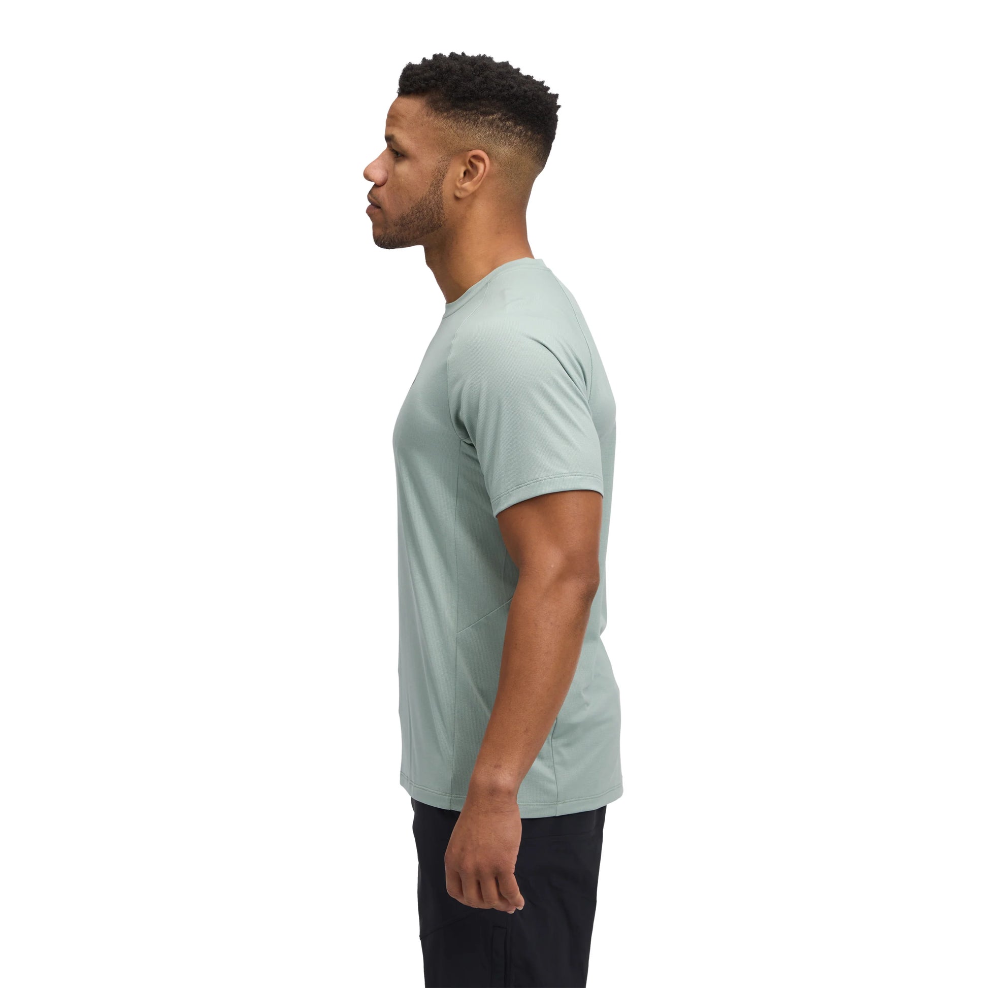 Man wearing a light green t-shirt on a white background