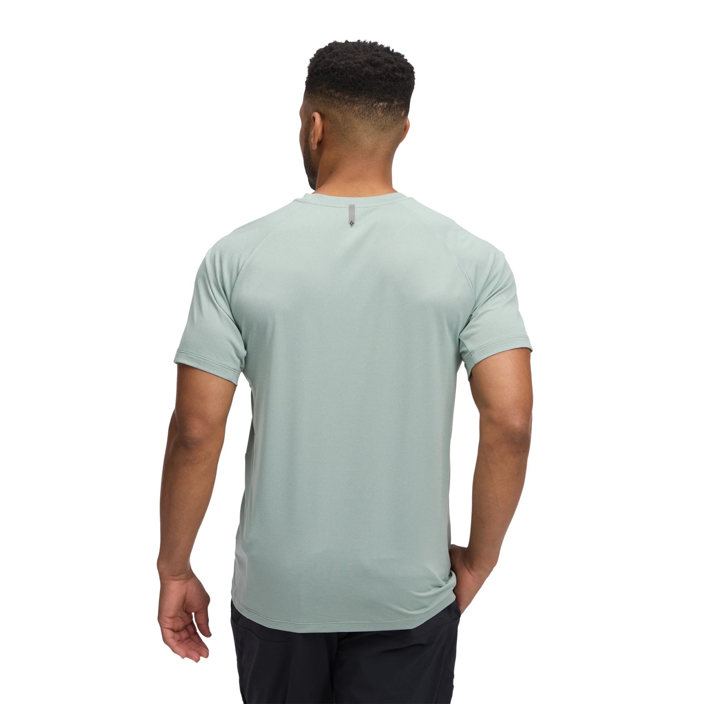 Man wearing a light green t-shirt on a white background