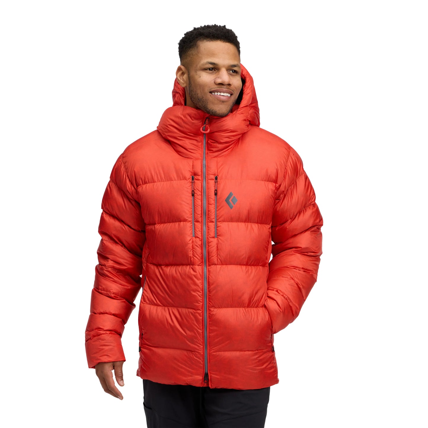 Man wearing a red puffer jacket on a white background