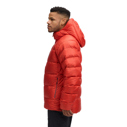 Person wearing a red puffer jacket on a white background