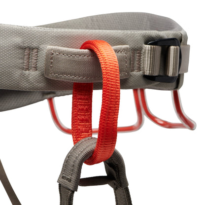 Close-up of a gray harness with red straps on a white background