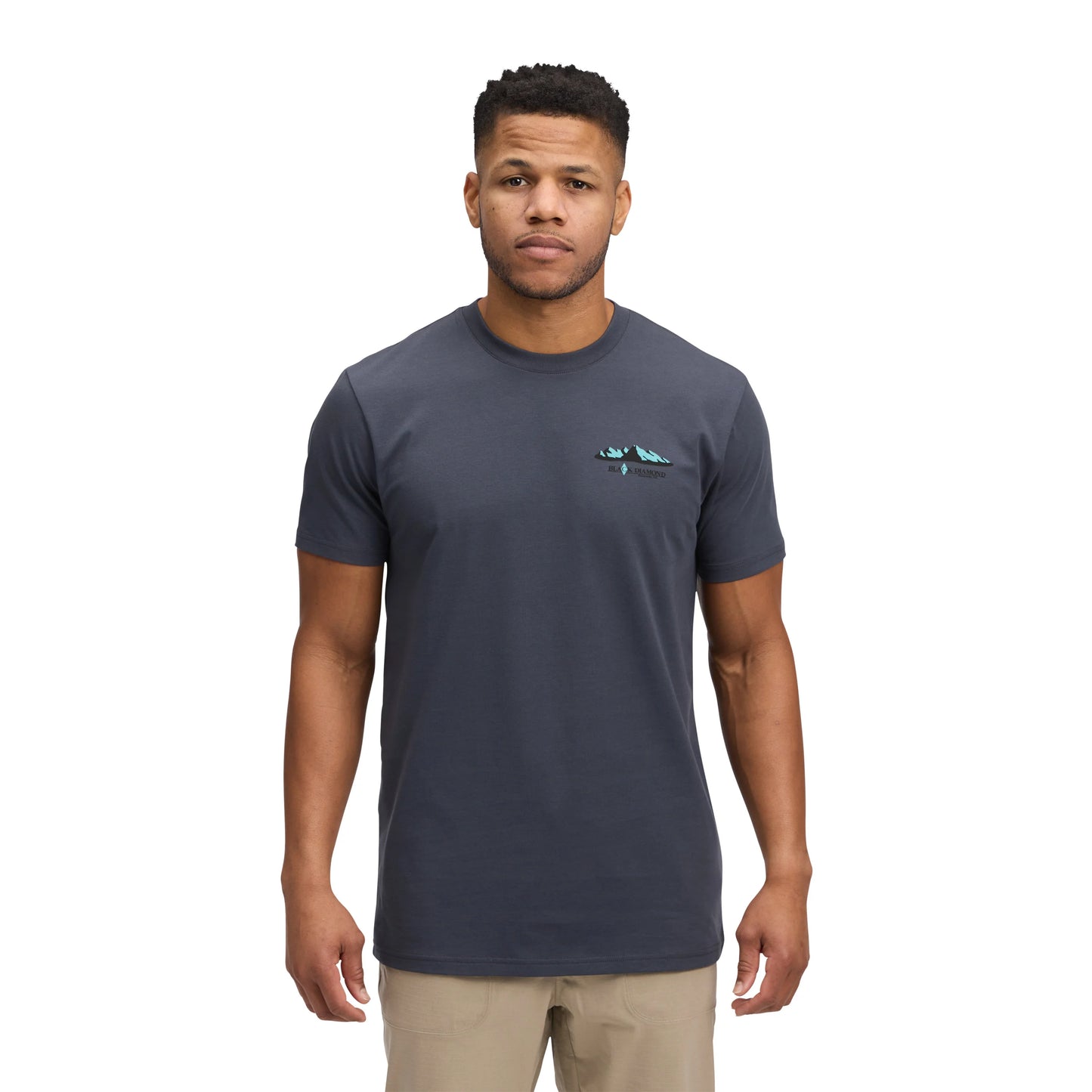 Man wearing a dark gray t-shirt with a small logo on a white background