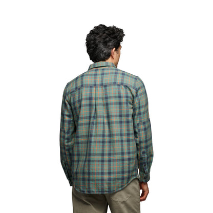 Person wearing a plaid shirt on a white background