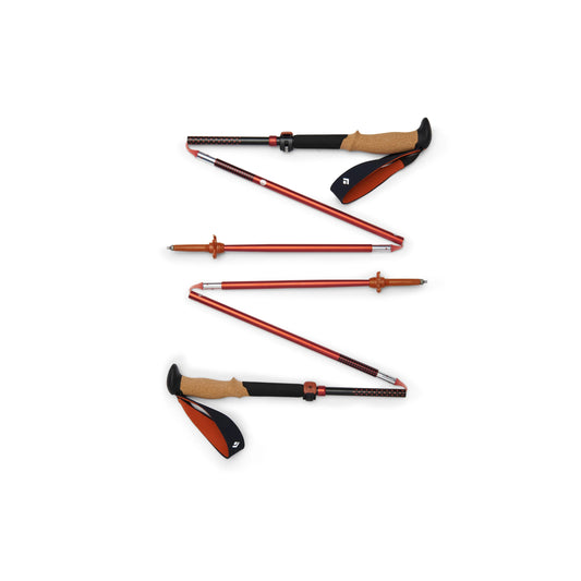 Set of hiking poles with red shafts and black and brown grips on a white background