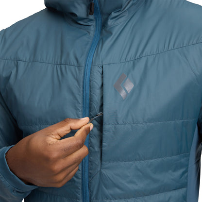 Blue jacket with a hand zipping it up on a white background