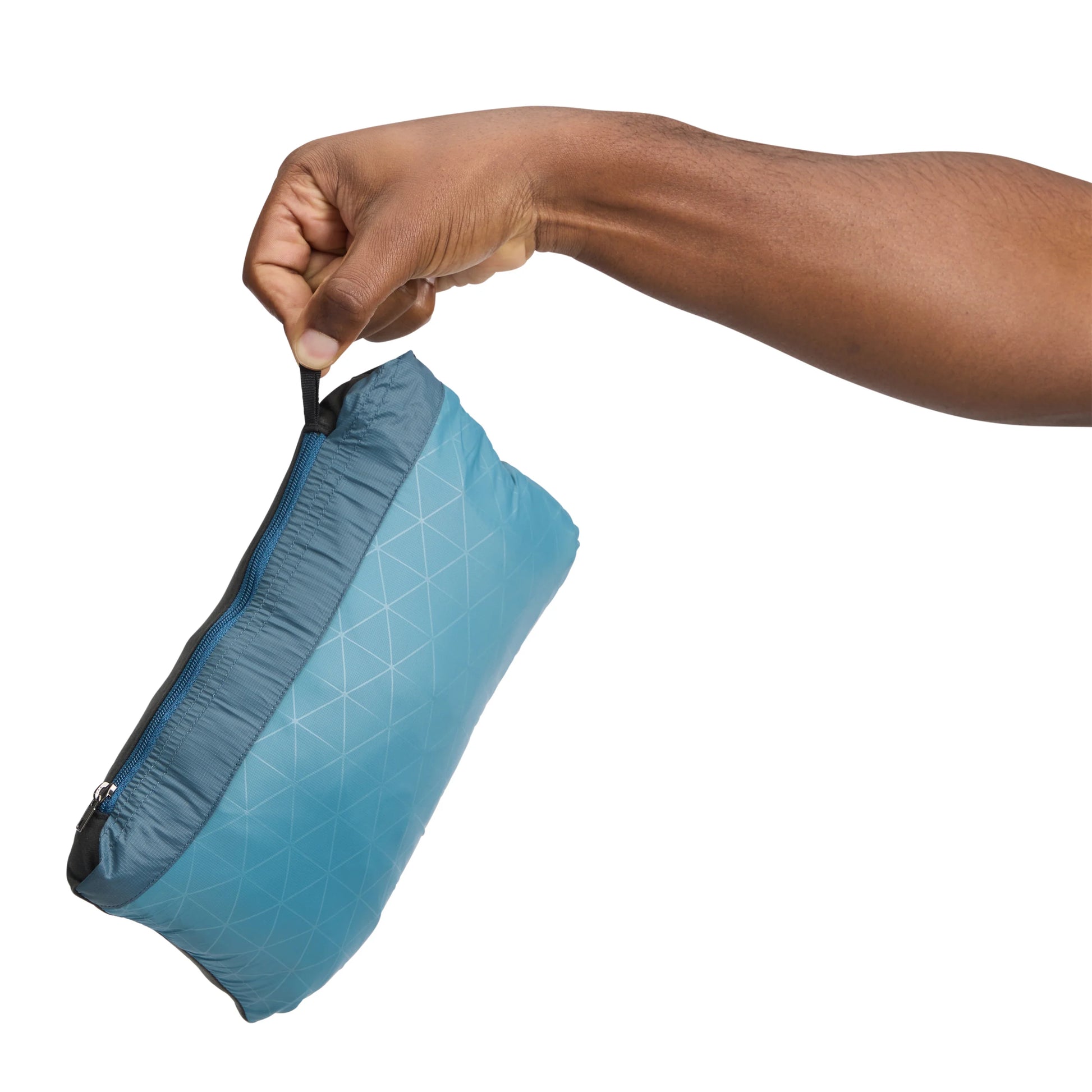 Hand opening a blue compression sack on a white background