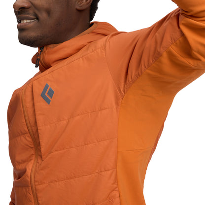 Person wearing an orange jacket with a brand logo on a white background