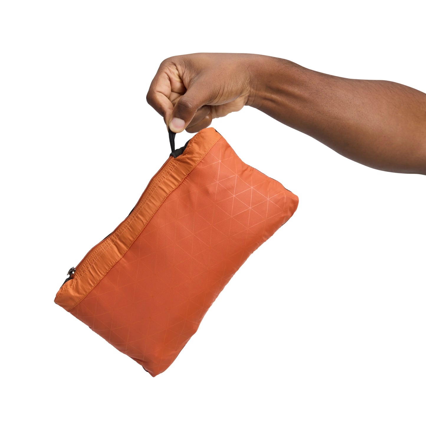 Hand opening an orange drawstring bag on a white background
