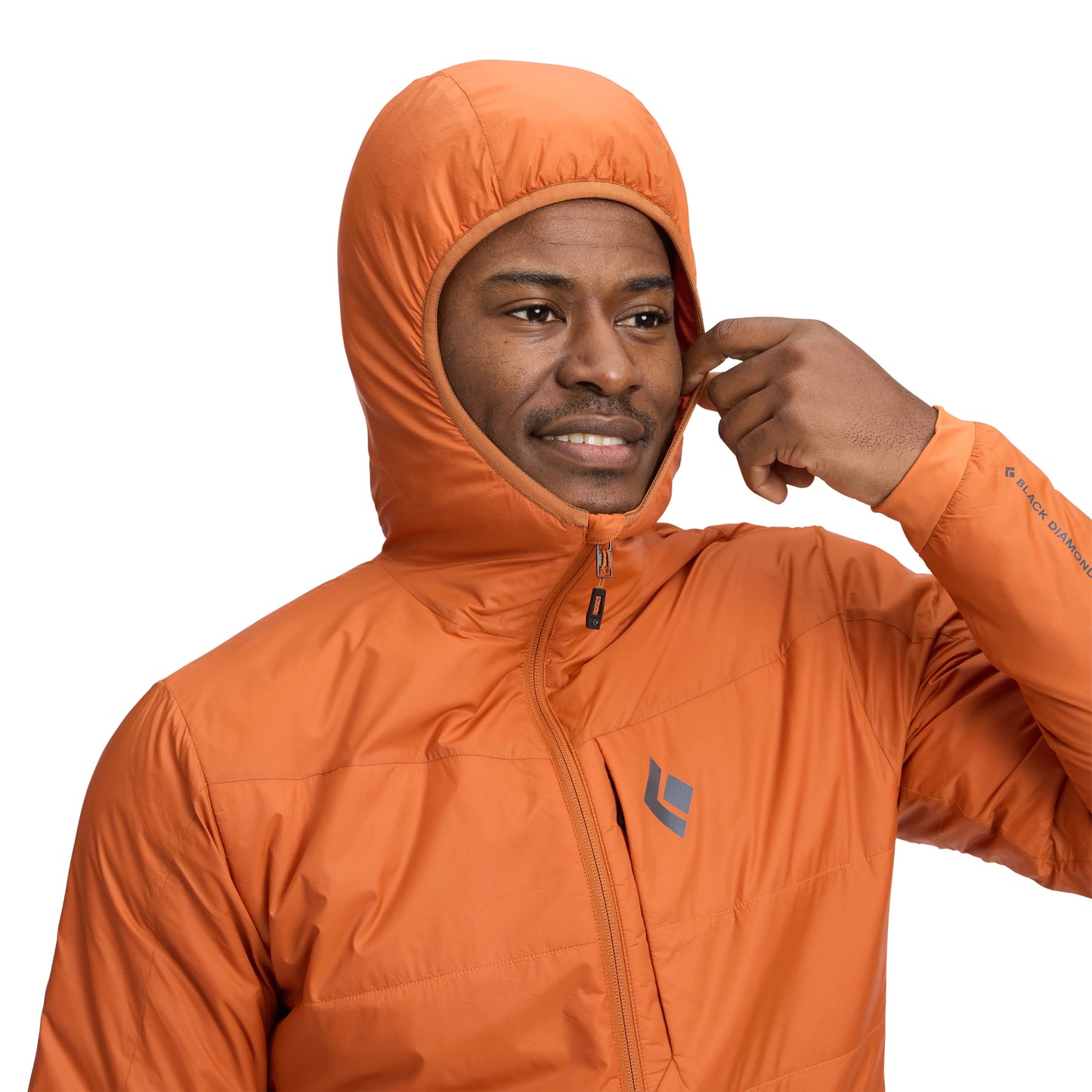 Man wearing an orange jacket with a brand logo on a white background