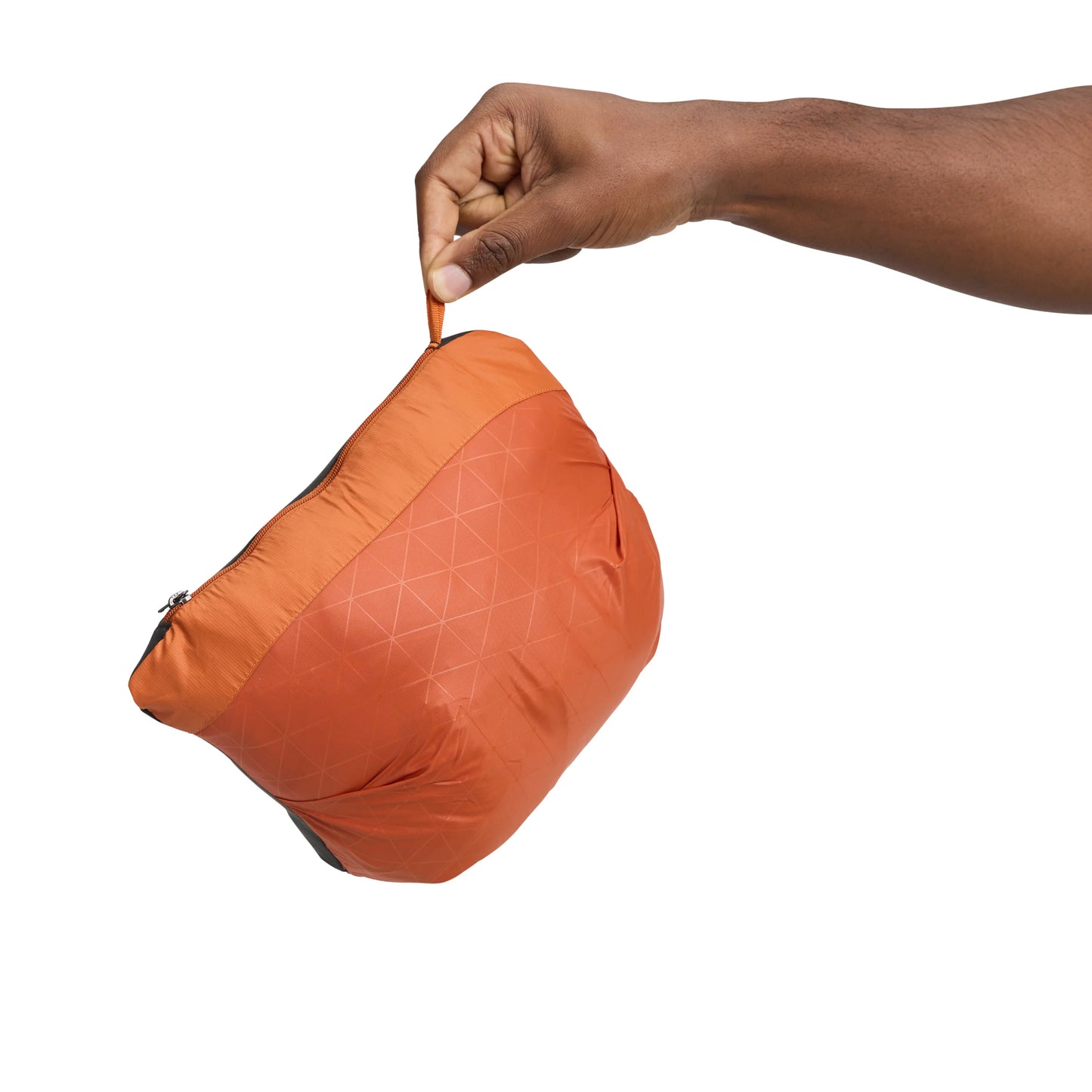 Orange travel pouch being held by a hand on a white background