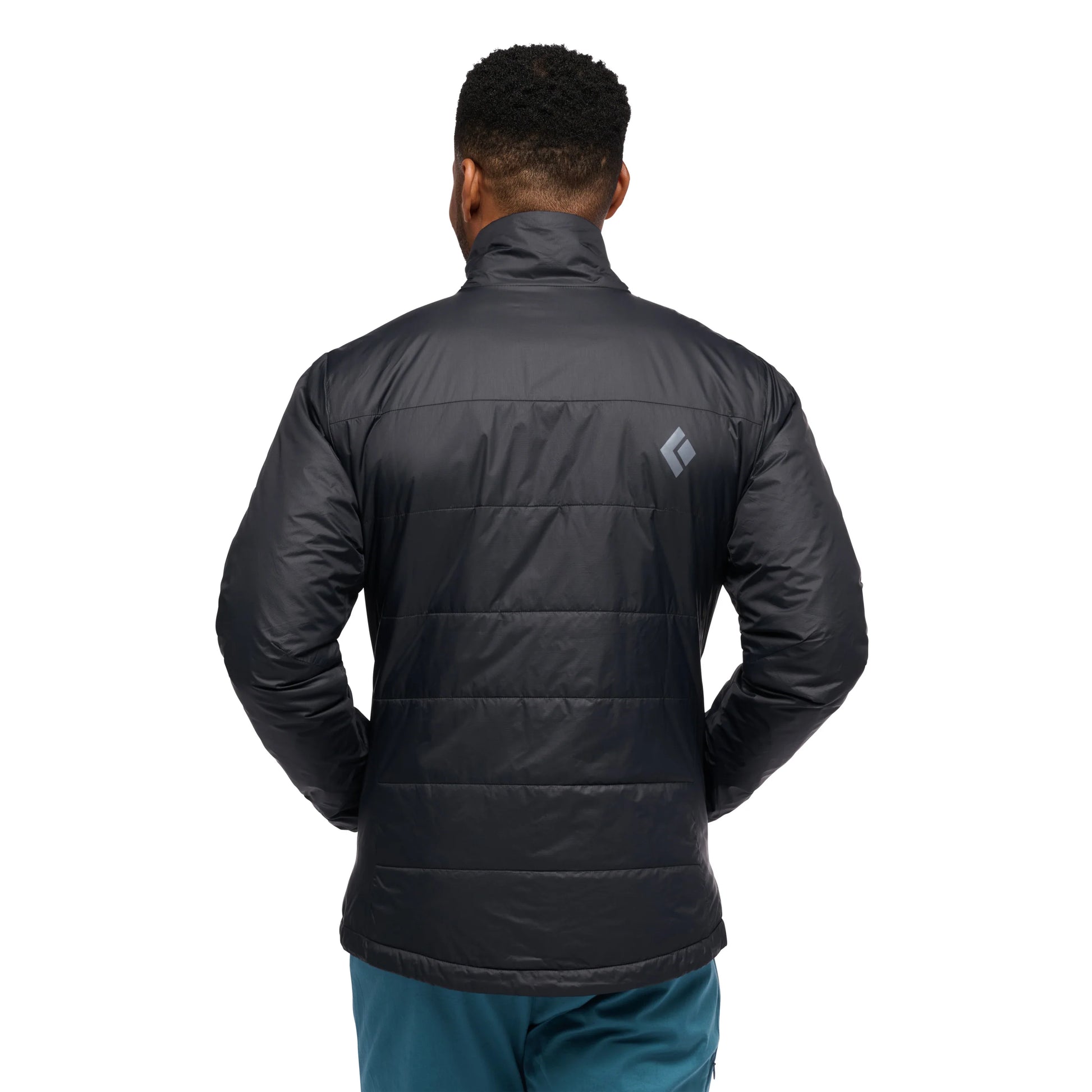 Person wearing a black puffer jacket with a visible brand logo on the back, standing against a white background.