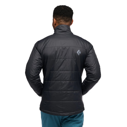 Person wearing a black puffer jacket with a visible brand logo on the back, standing against a white background.