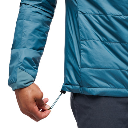 Close-up of a person wearing a blue puffer jacket with a white background