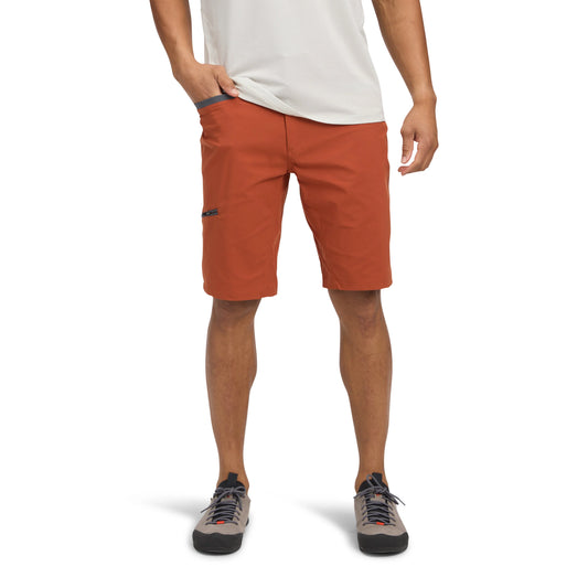 Person wearing orange shorts on a white background