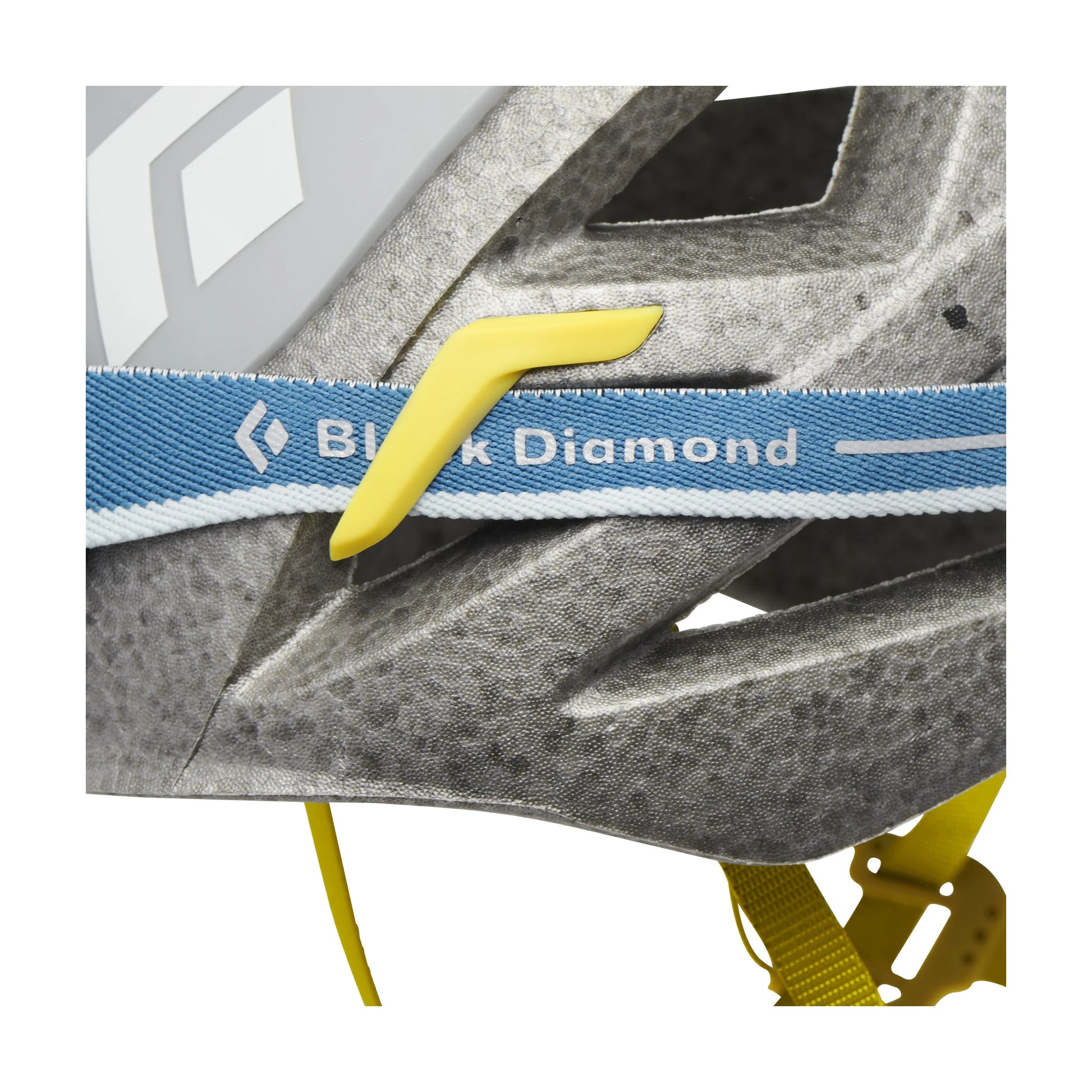 Close-up of a climbing helmet with a Black Diamond strap on a white background